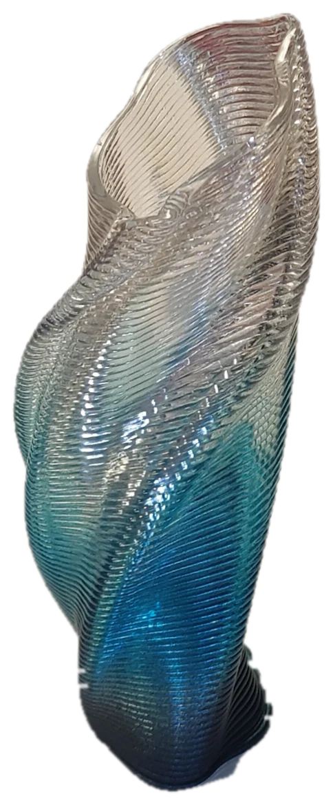 The Twist Vase printed in clear to blue filament, its spiral layer lines catching the light